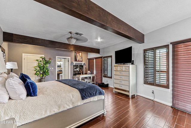 701 La Cruz Dr, El Paso, TX 79902 - bedroom with baseboards, dark wood-style floors, a textured ceiling, visible vents, and beamed ceiling