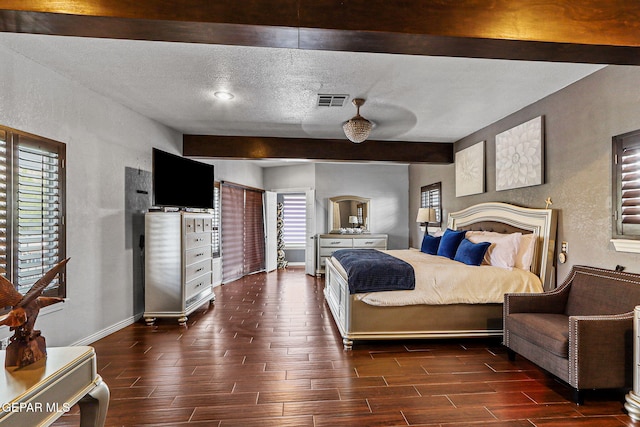 701 La Cruz Dr, El Paso, TX 79902 - bedroom featuring visible vents, a textured wall, a textured ceiling, beamed ceiling, and wood finish floors