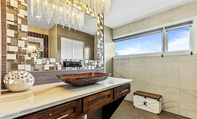 701 La Cruz Dr, El Paso, TX 79902 - bathroom featuring a chandelier, vanity, tile walls, and backsplash