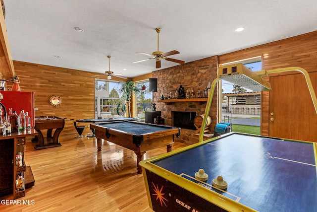 701 La Cruz Dr, El Paso, TX 79902 - recreation room featuring ceiling fan, pool table, light wood-type flooring, a stone fireplace, and wood walls