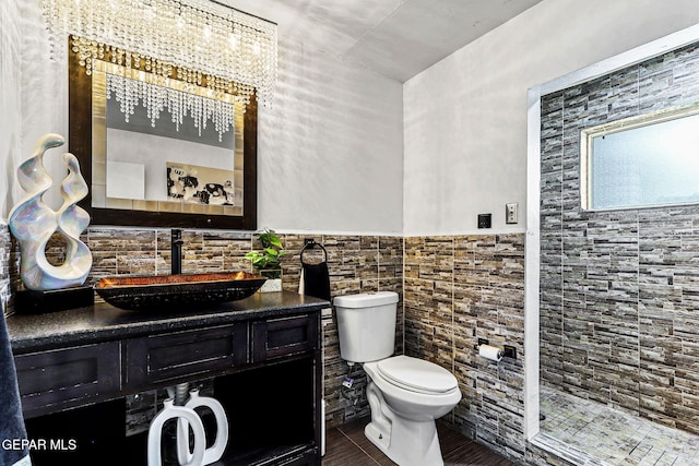 701 La Cruz Dr, El Paso, TX 79902 - bathroom featuring toilet, vanity, a wainscoted wall, and tile walls