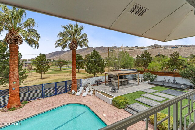 701 La Cruz Dr, El Paso, TX 79902 - view of pool featuring a fenced backyard, a lawn, a patio area, a mountain view, and a fenced in pool