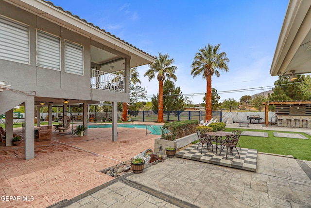 701 La Cruz Dr, El Paso, TX 79902 - view of patio with a fenced in pool, a balcony, a fenced backyard, and outdoor dining space