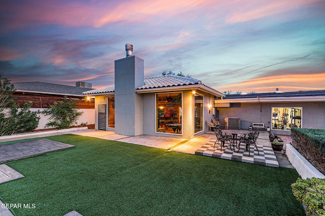 701 La Cruz Dr, El Paso, TX 79902 - back of house with a patio area, a yard, a chimney, a tile roof, and stucco siding