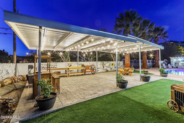 701 La Cruz Dr, El Paso, TX 79902 - patio at night with a yard, a fenced in pool, and fence private yard