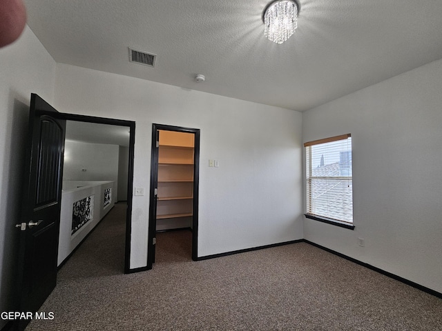 3864 Tierra Campa Dr, El Paso, TX 79938 - unfurnished bedroom featuring visible vents, baseboards, a walk in closet, and carpet flooring