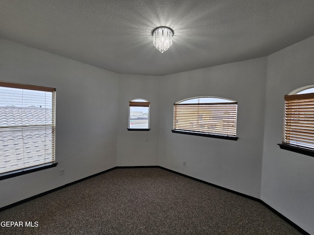 3864 Tierra Campa Dr, El Paso, TX 79938 - empty room featuring carpet, baseboards, and a textured ceiling