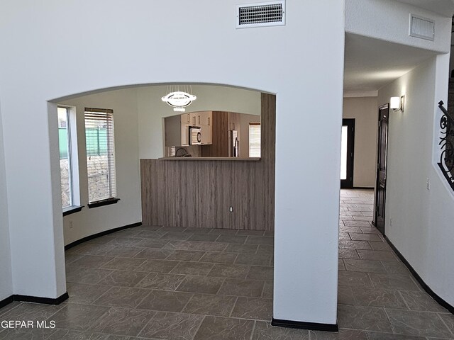 3864 Tierra Campa Dr, El Paso, TX 79938 - corridor with visible vents, baseboards, arched walkways, and stone finish floor