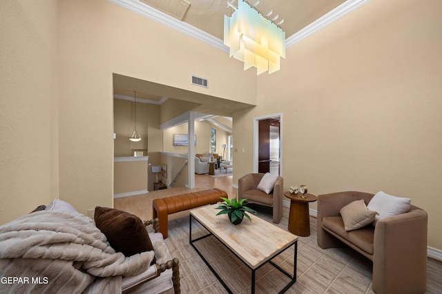 living room with crown molding, a high ceiling, baseboards, and visible vents