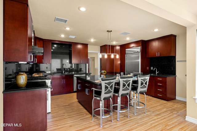 kitchen featuring dark countertops, a kitchen island, and appliances with stainless steel finishes