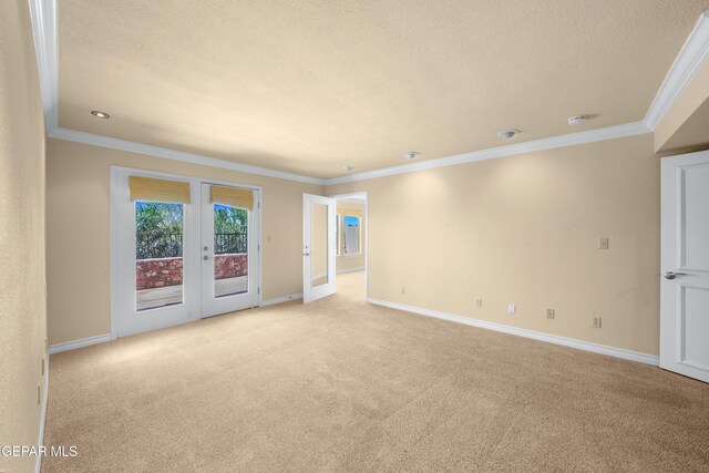 unfurnished room featuring baseboards, french doors, light colored carpet, and crown molding