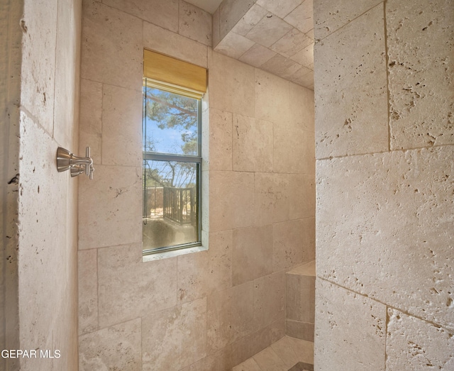 bathroom with tiled shower