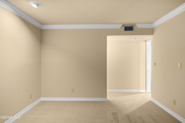 unfurnished room with light carpet, baseboards, ornamental molding, and visible vents