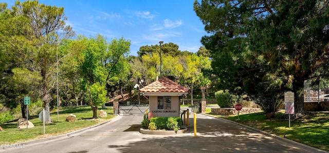 exterior space featuring a tiled roof, stucco siding, and a front yard