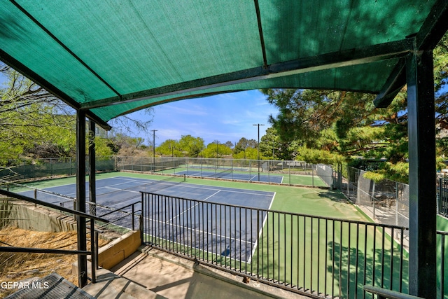 view of tennis court featuring fence