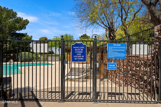 view of gate with fence