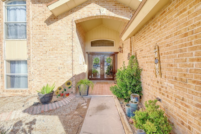 property entrance with brick siding and french doors