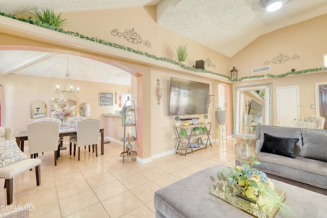 living room with lofted ceiling, visible vents, light tile patterned flooring, baseboards, and a textured ceiling
