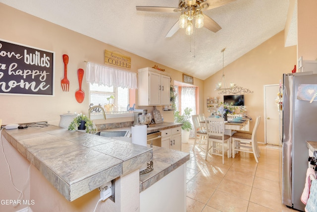 kitchen featuring ceiling fan, decorative light fixtures, a textured ceiling, appliances with stainless steel finishes, and white cabinetry