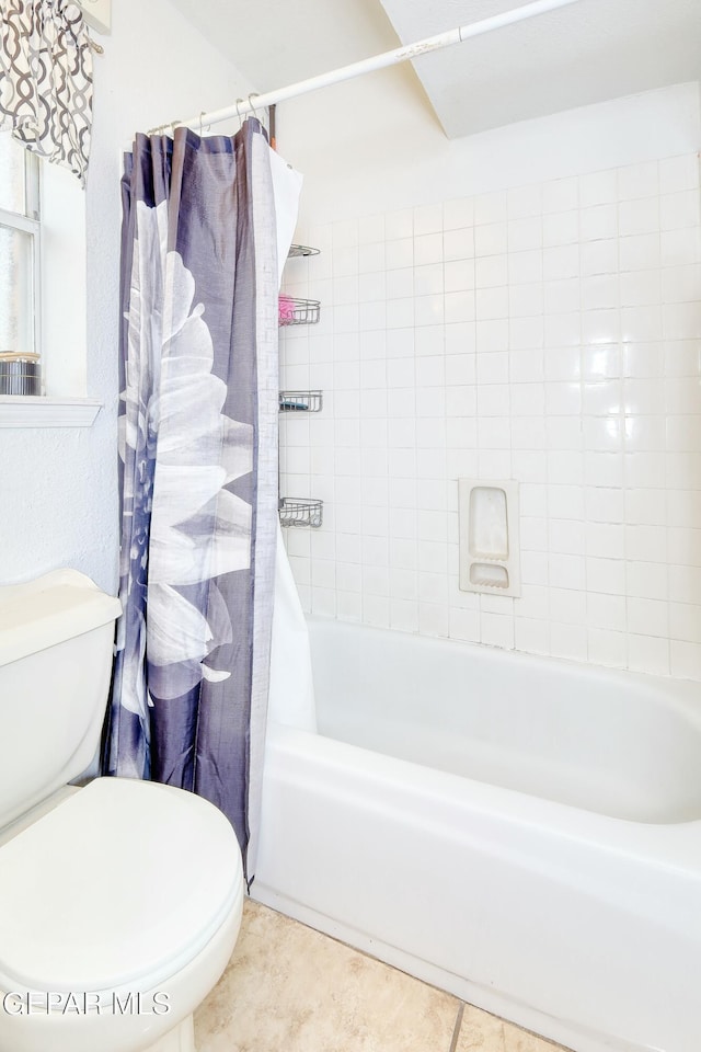 bathroom featuring toilet, tile patterned flooring, and shower / bath combo with shower curtain