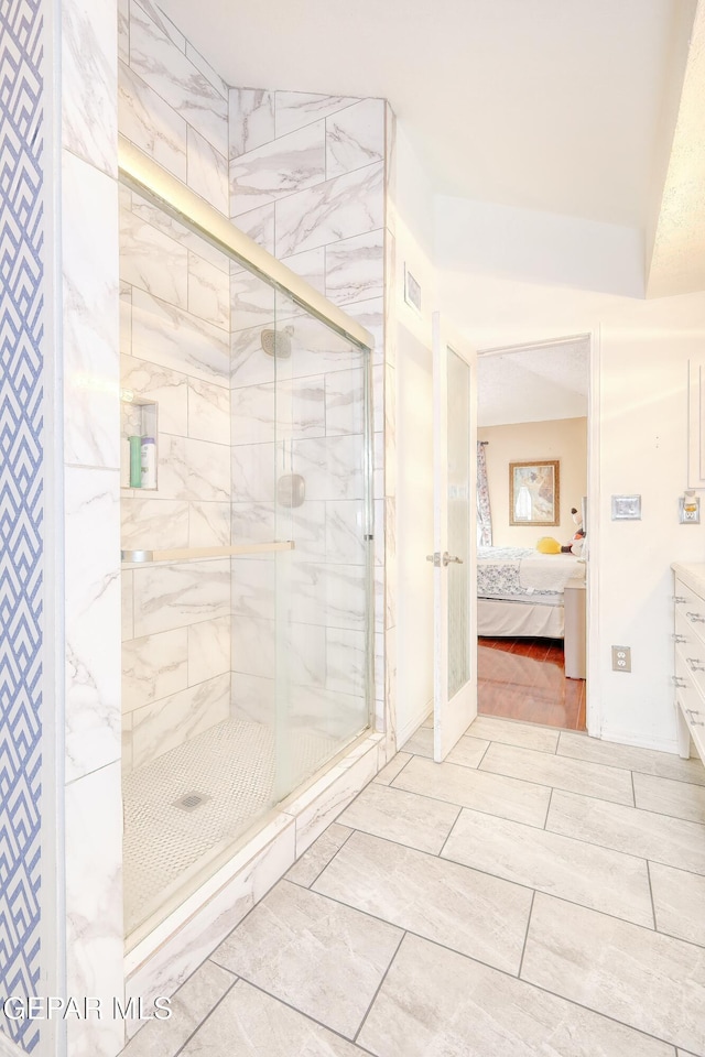 ensuite bathroom featuring visible vents, ensuite bath, and a stall shower