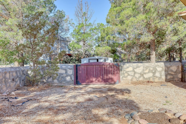 view of yard with fence and a gate
