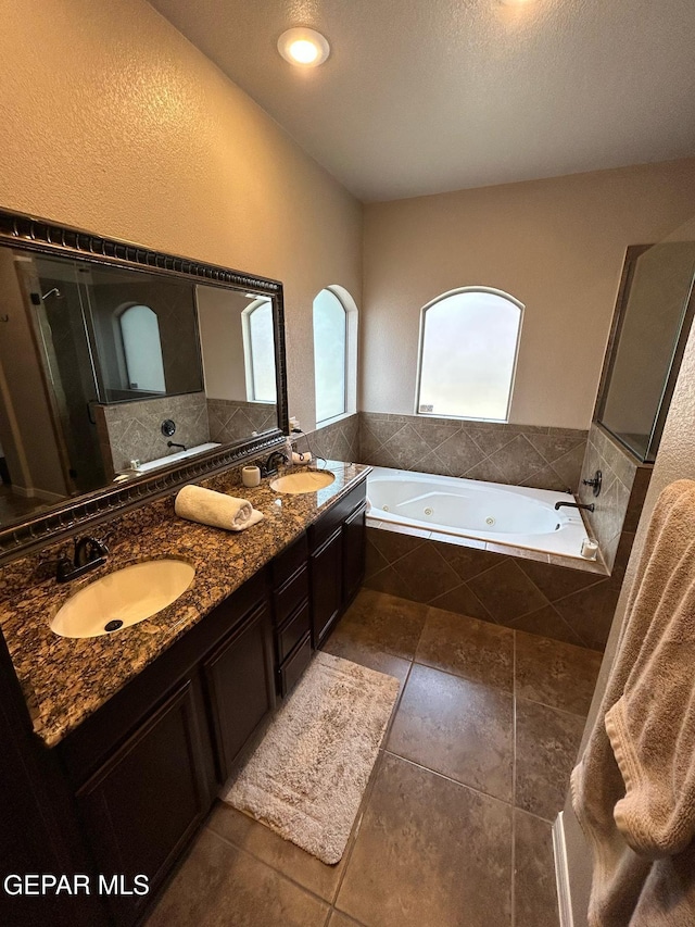 1250 Franklin Raven Place, El Paso, TX 79912 - full bath with tile patterned flooring, a sink, double vanity, and a tub with jets