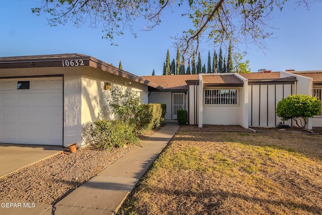 10632 Park View Cir, El Paso, TX 79935 - view of front of home featuring a shingled roof, a garage, and stucco siding