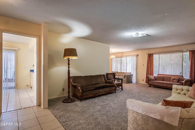 10632 Park View Cir, El Paso, TX 79935 - living room featuring light tile patterned floors, light colored carpet, an inviting chandelier, and a textured ceiling