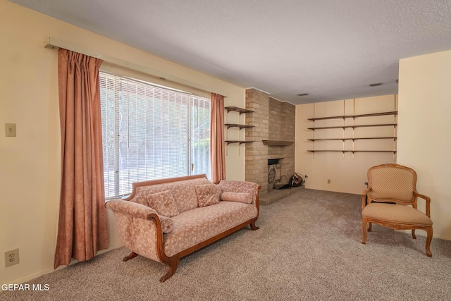 10632 Park View Cir, El Paso, TX 79935 - sitting room featuring carpet flooring, a brick fireplace, a textured ceiling, and visible vents