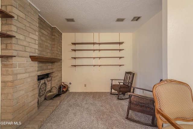10632 Park View Cir, El Paso, TX 79935 - living area with a textured ceiling, a brick fireplace, carpet, and visible vents