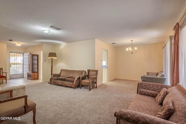 10632 Park View Cir, El Paso, TX 79935 - carpeted living area with a notable chandelier, visible vents, and a textured ceiling