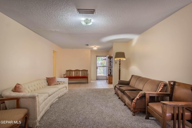 10632 Park View Cir, El Paso, TX 79935 - carpeted living room featuring tile patterned flooring, visible vents, and a textured ceiling