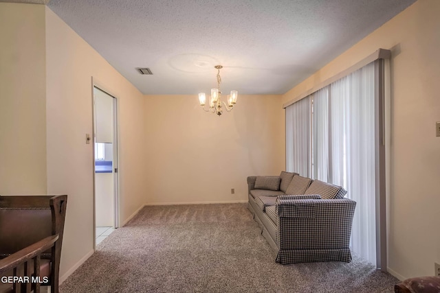 10632 Park View Cir, El Paso, TX 79935 - sitting room with visible vents, a chandelier, carpet floors, and a textured ceiling