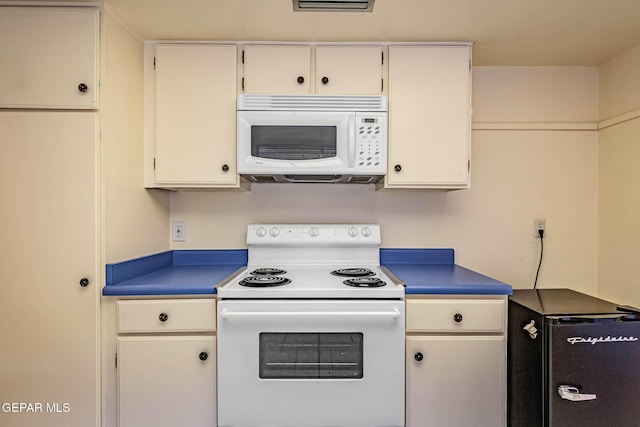 10632 Park View Cir, El Paso, TX 79935 - kitchen featuring white cabinets, white appliances, and dark countertops