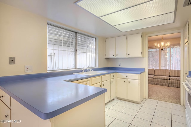 10632 Park View Cir, El Paso, TX 79935 - kitchen with a chandelier, light tile patterned floors, a peninsula, visible vents, and a sink