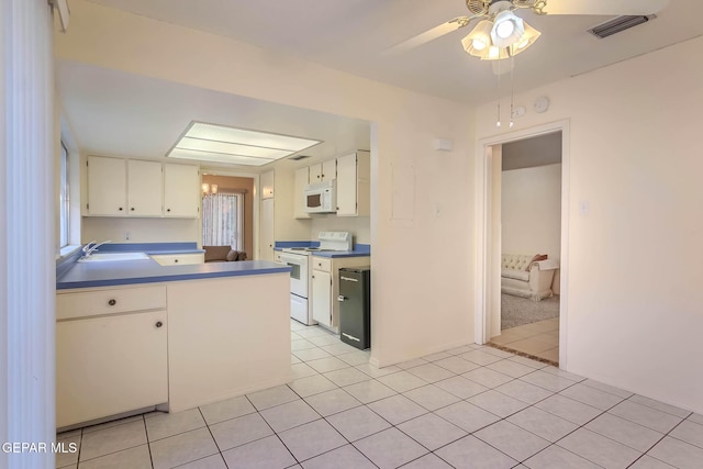 10632 Park View Cir, El Paso, TX 79935 - kitchen with visible vents, a sink, white appliances, white cabinetry, and light tile patterned flooring