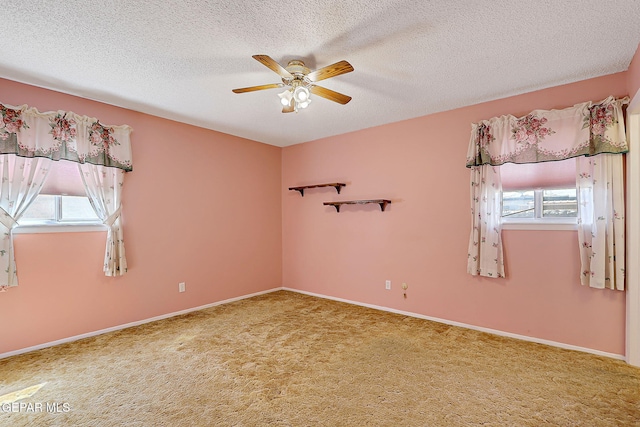 unfurnished room with baseboards, carpet flooring, a textured ceiling, and a ceiling fan