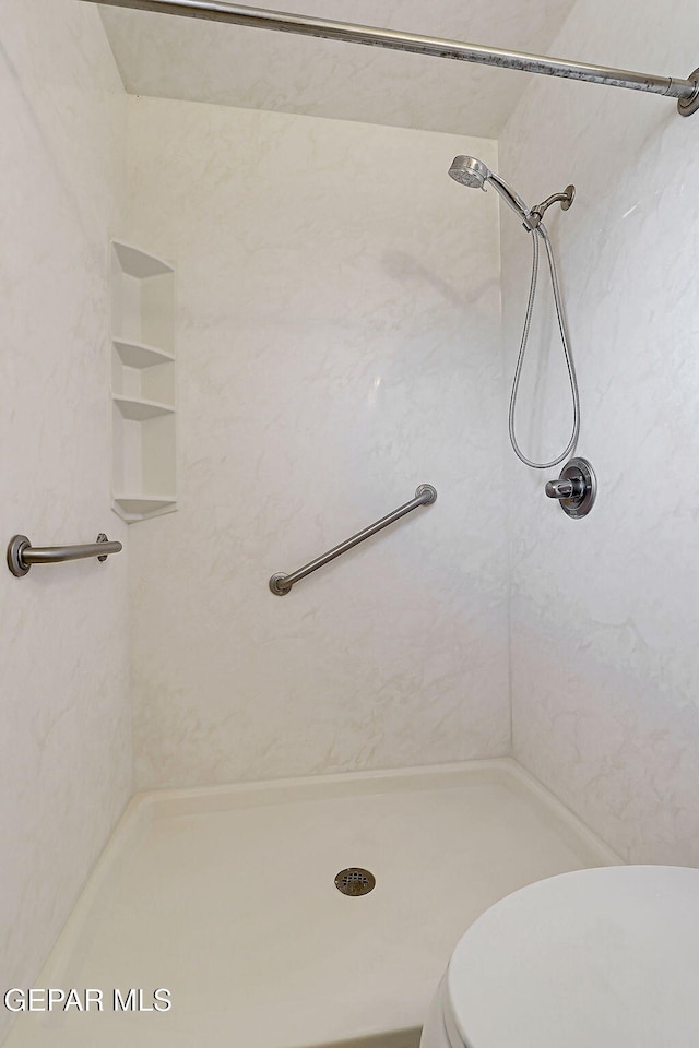 full bath featuring toilet and a shower