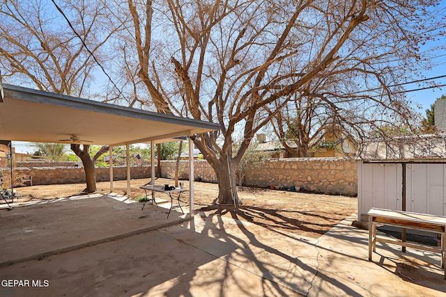 view of patio with a fenced backyard and a ceiling fan