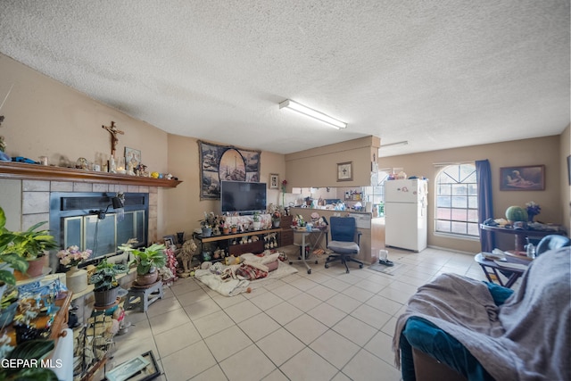 610 Gurdev Cir, Socorro, TX 79927 - tiled living room featuring a tile fireplace and a textured ceiling