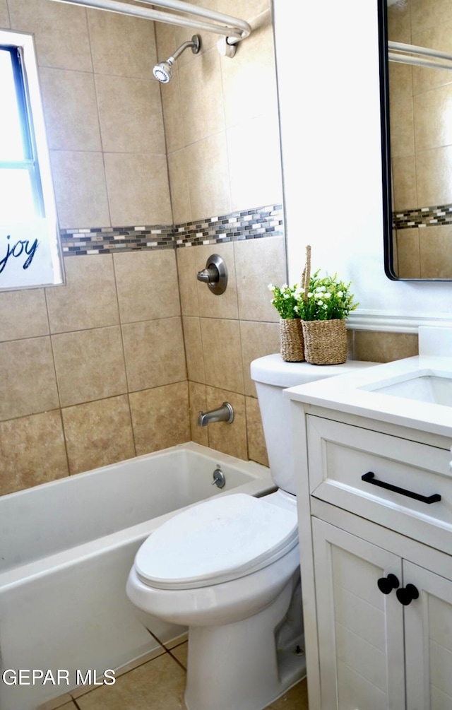 full bath with toilet, vanity, tile patterned flooring, and washtub / shower combination