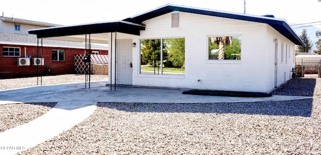 back of house with a patio area and brick siding