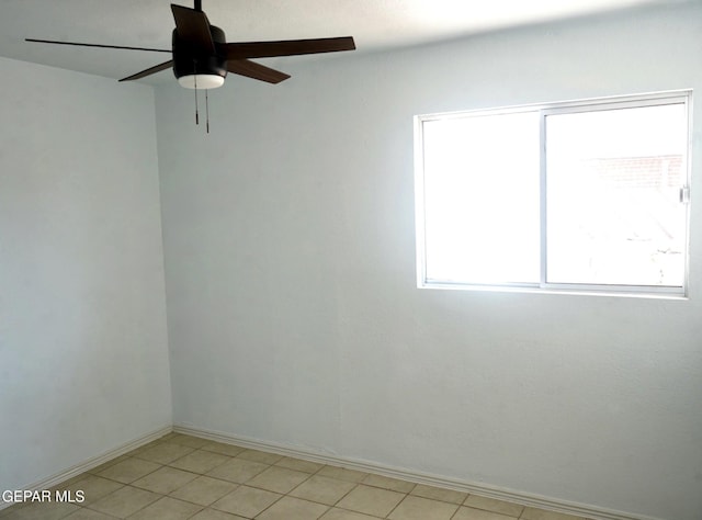 empty room with baseboards and a ceiling fan