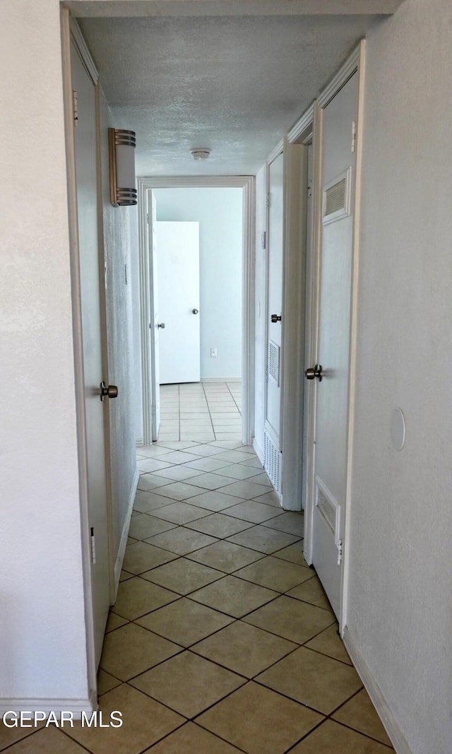 hallway with light tile patterned floors