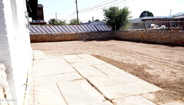 view of yard with fence and a patio