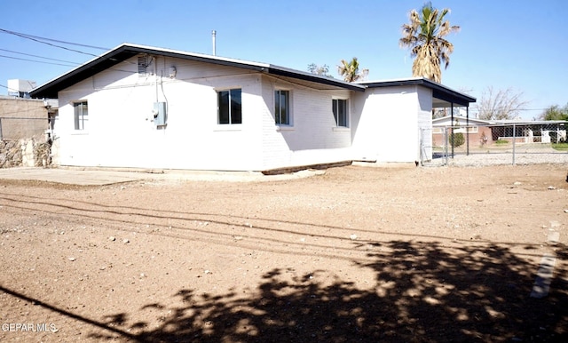 back of house with fence