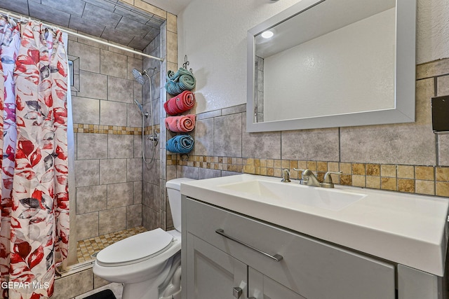 702 Thompson Rd, San Elizario, TX 79849 - bathroom with tile walls, toilet, a shower stall, and vanity