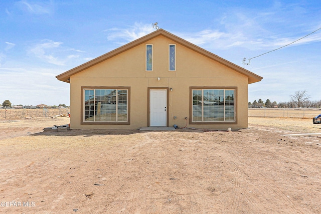 702 Thompson Rd, San Elizario, TX 79849 - rear view of property featuring stucco siding and fence