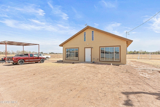 702 Thompson Rd, San Elizario, TX 79849 - view of front of property with a carport, stucco siding, and fence